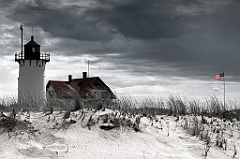 Storm Appproaching Race Point Light with American Flag Lit